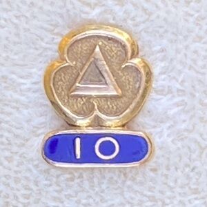Set of 2 gold pins for city services one marked 14k on 10k one with a diamond